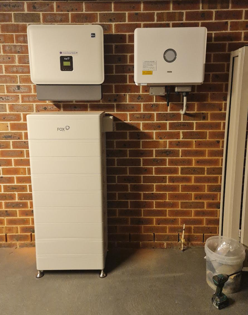 Close-up of a neatly finished battery and inverter installation